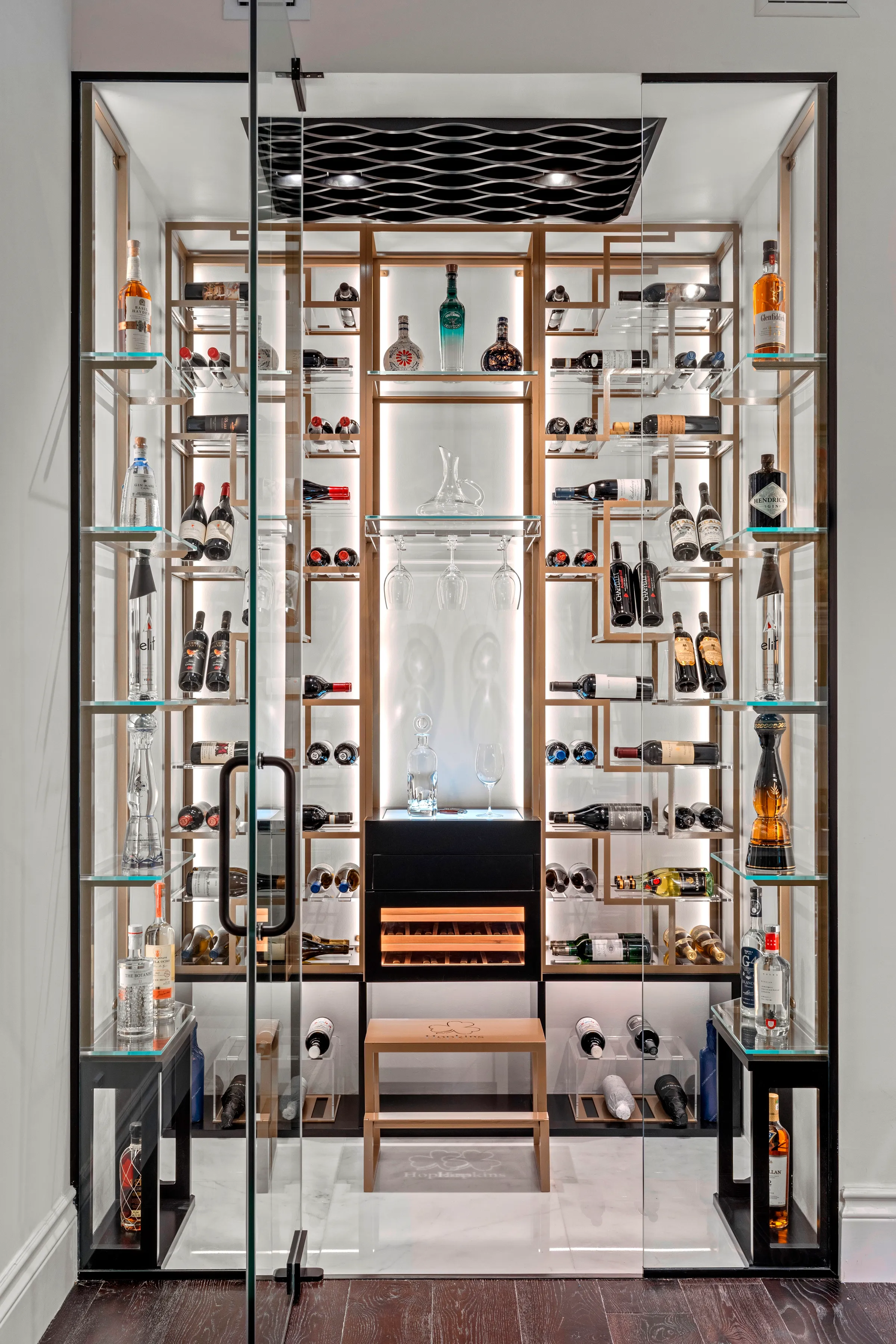 Custom wine cellar at Bauhinia, Delray Beach, Florida — floor-to-ceiling racking behind glass
