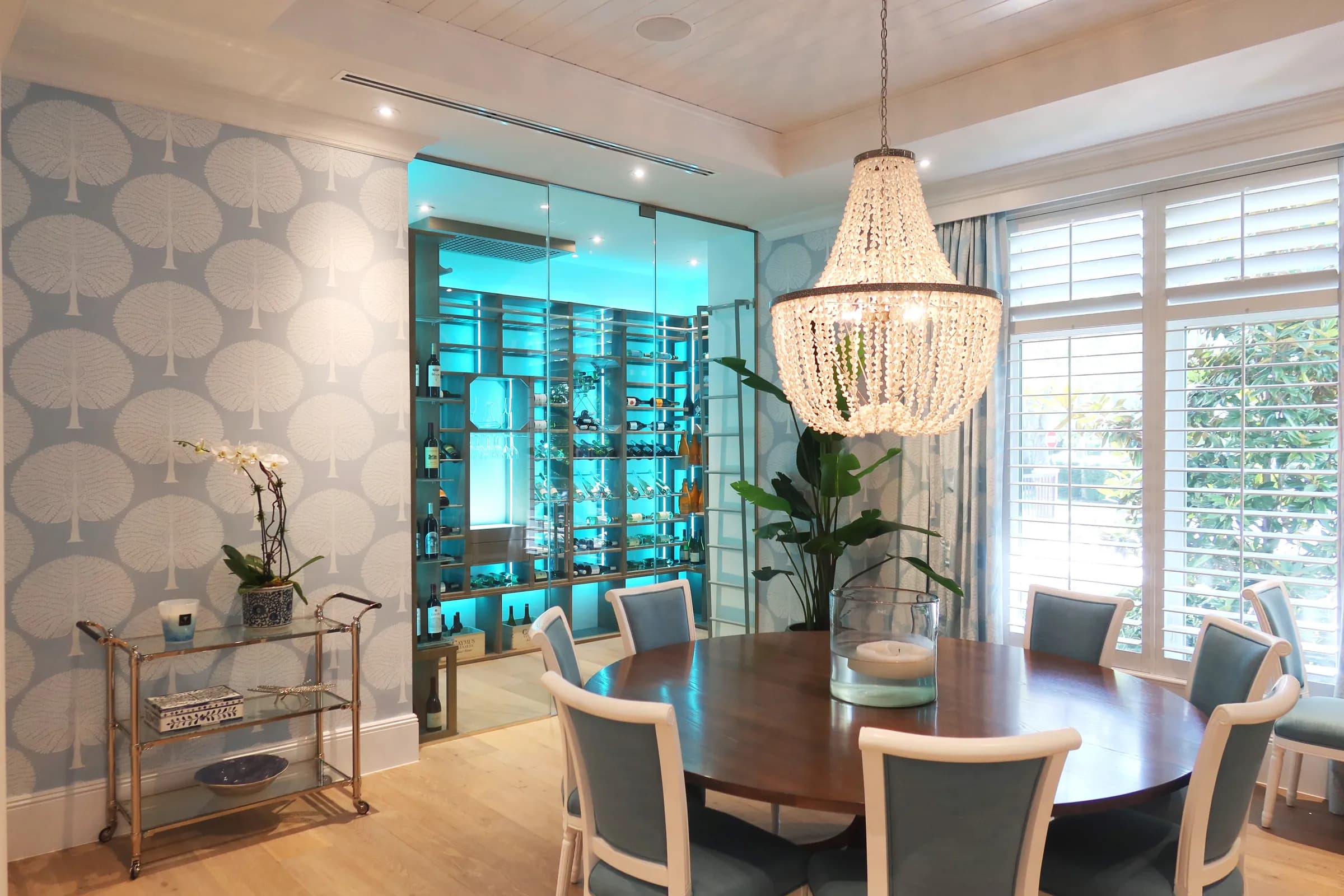 Transitional wine room in Pinecrest, Florida — wood and metal racking with a custom technical ceiling housing the cooling equipment